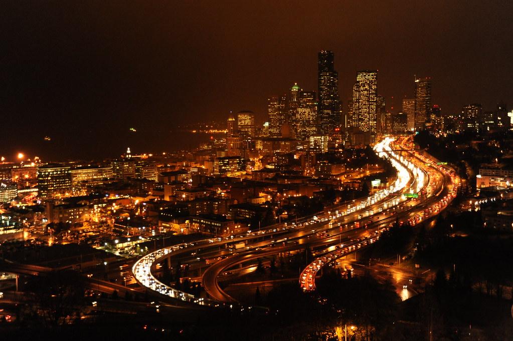I-5 light trails curving into downtown Seattle on a wet night, seen from Beacon Hill